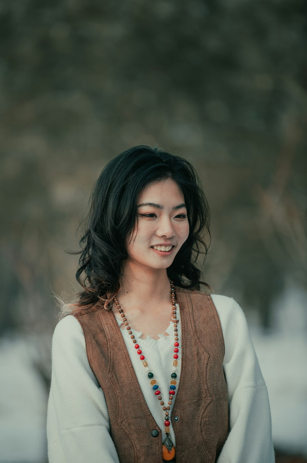 Portrait of a woman with dark hair and a warm smile