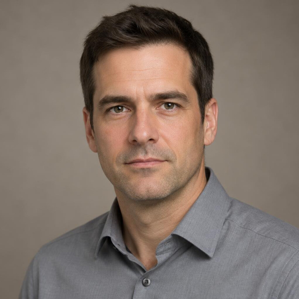 Portrait of a man in a collared shirt in a neutral studio